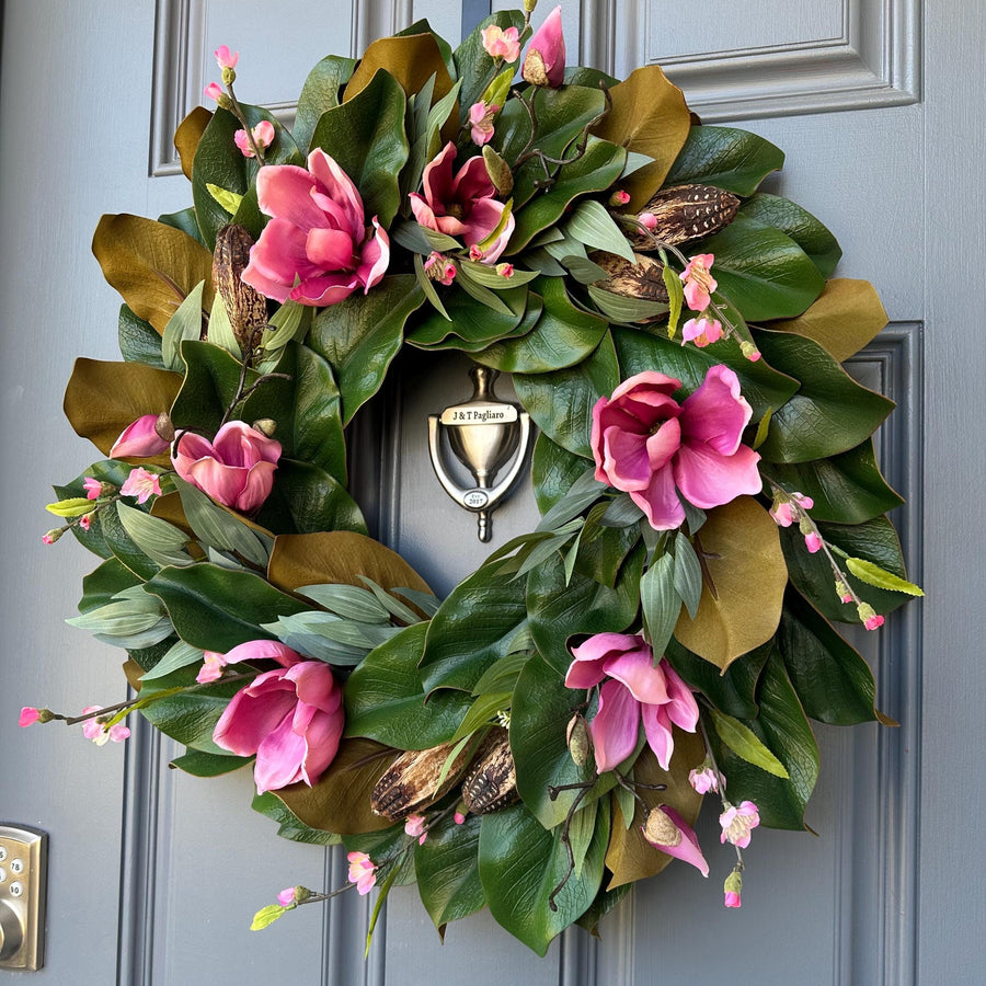 Magnolia wreath for front door with realistic pink magnolia blooms nestled in green magnolia leaves with pods, ferns,blossoms all handmade.