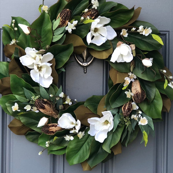 Magnolia wreath for front door with realistic white magnolia blooms nestled in green magnolia leaves with pods