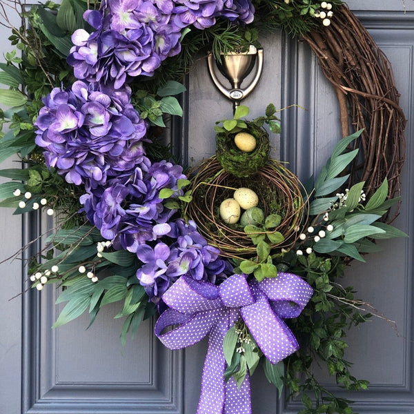Purple spring front door wreath, purple hydrangeas, a bird nest with eggs