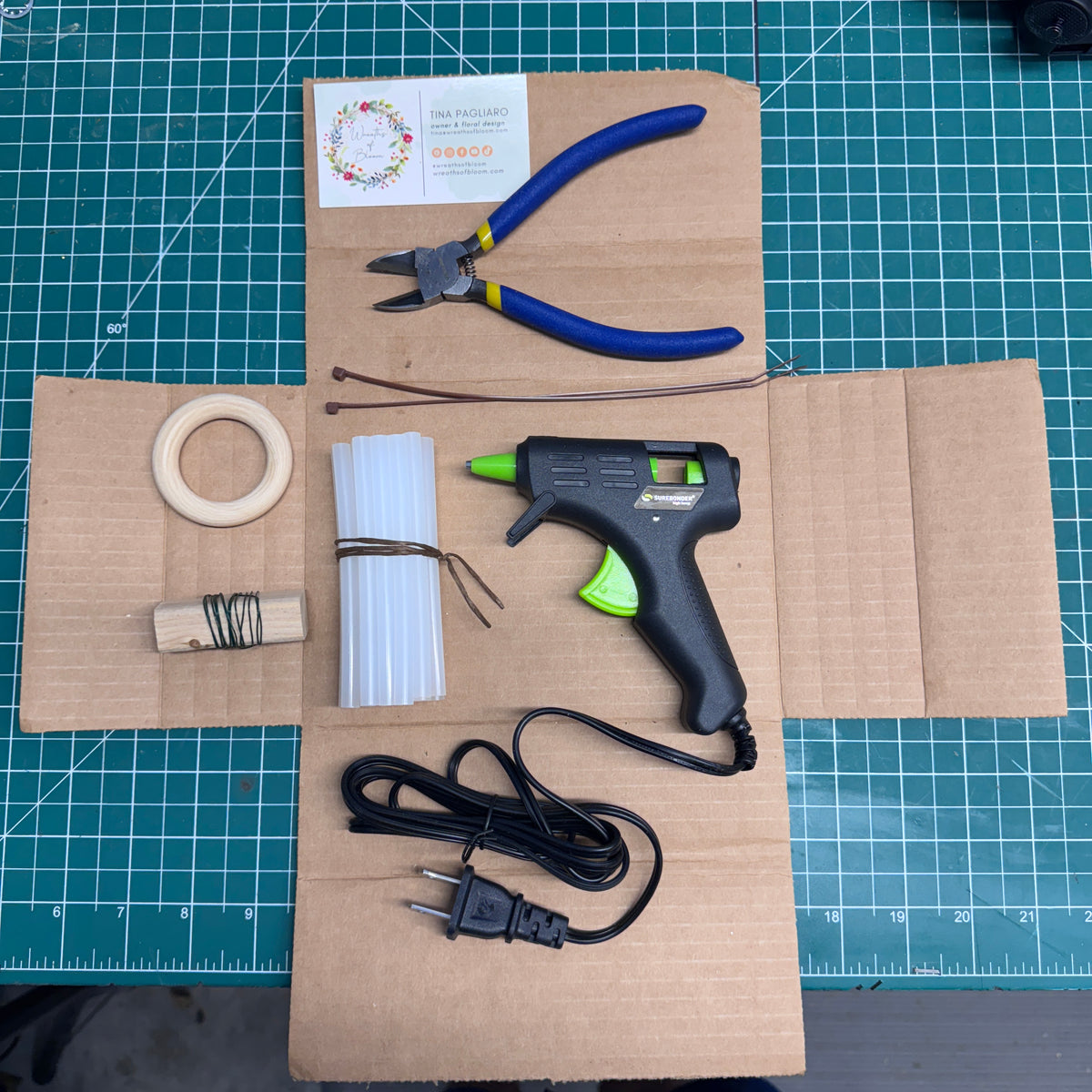 The Toolkit comes with a hot glue gun with glue sticks, wire cutters, florist wire, a wooden loop to hang the wreath and zip ties to attach the loop.