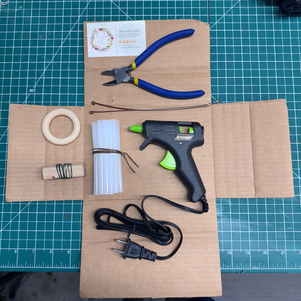 The Toolkit comes with a hot glue gun with glue sticks, wire cutters, florist wire, a wooden loop to hang the wreath and zip ties to attach the loop.