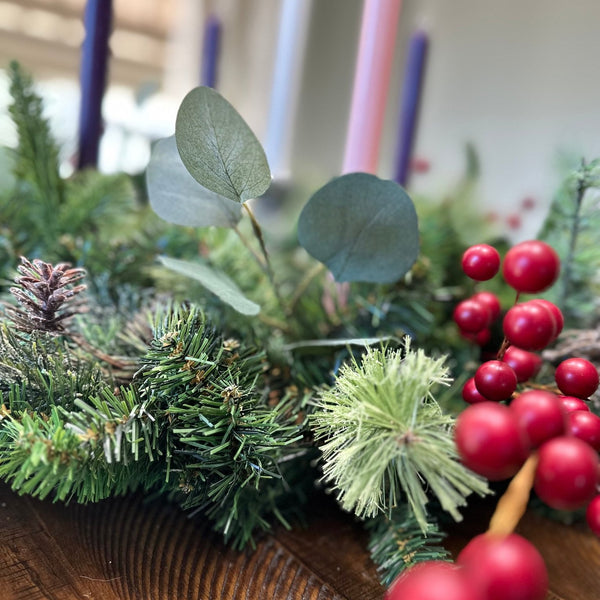 Advent wreath - detailed view of red berries, evergreen and eucalyptus