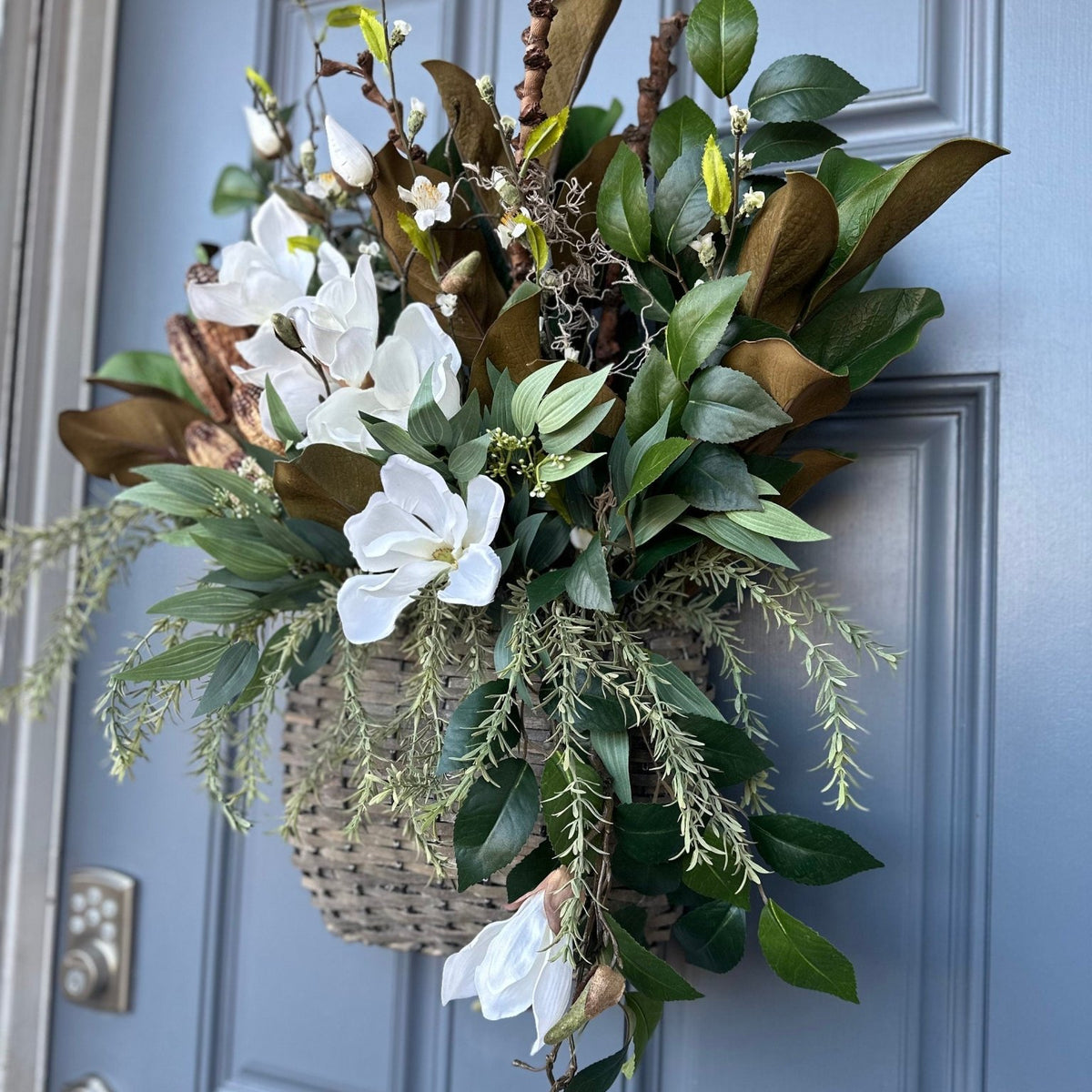 Basket for front door with magnolia florals and greenery with natural branches and pods 24"x21"x5. Matches wreath!!!