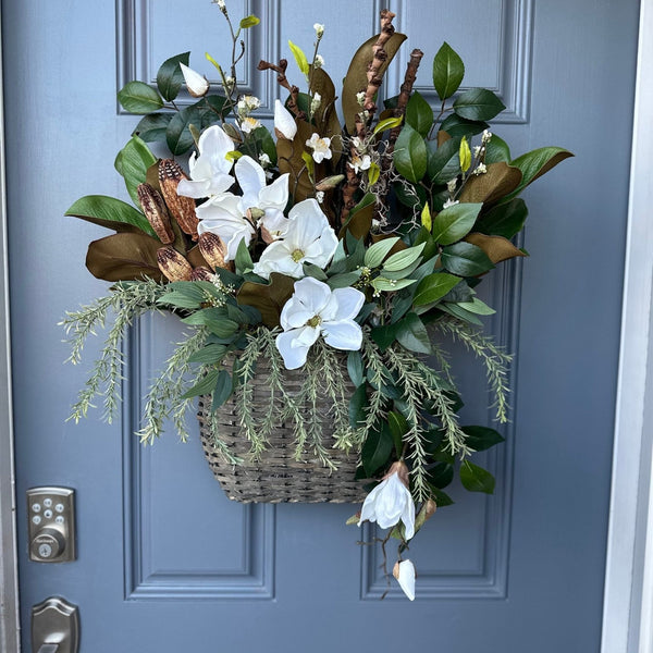 Basket for front door with magnolia florals and greenery with natural branches and pods 24"x21"x5. Matches wreath!!!