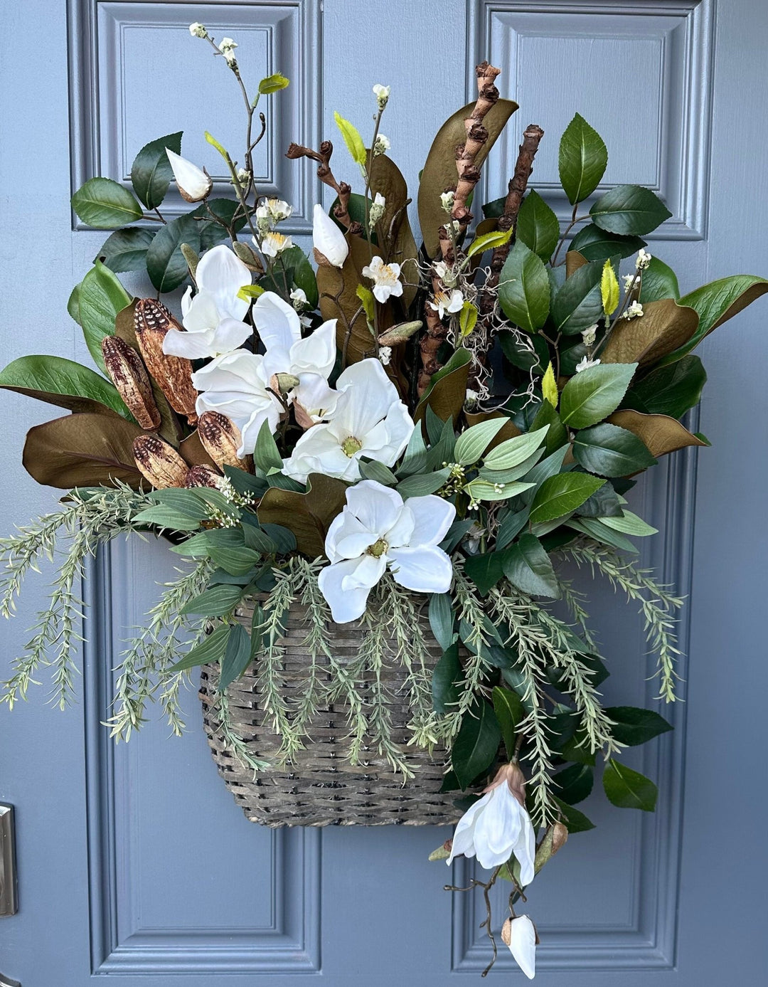 Basket for front door with magnolia florals and greenery with natural branches and pods 24"x21"x5. Matches wreath!!!