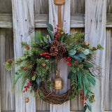 Christmas wreath, Pine wreath with red berries and brass bell. Faux natural looking design for entire winter season. Holiday decorating