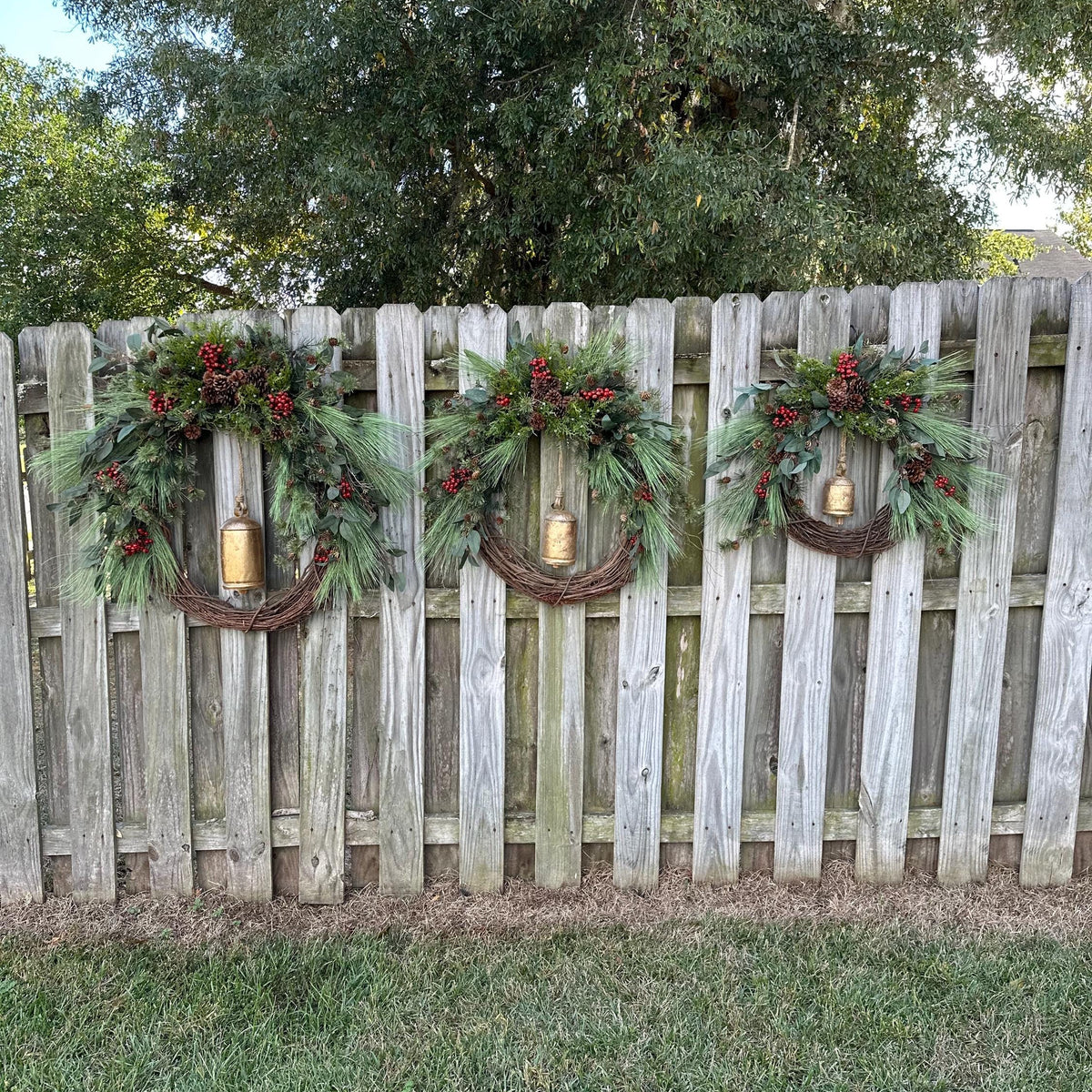 Christmas wreath, Pine wreath with red berries and brass bell. Faux natural looking design for entire winter season. Holiday decorating