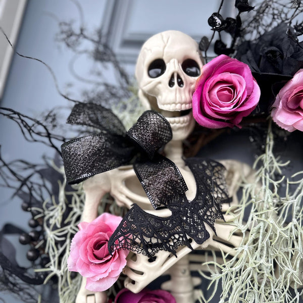 Halloween skeleton door wreath with a lantern that lights up, Moveable 36" skeleton holds light and is nestled in creepy moss and pink roses