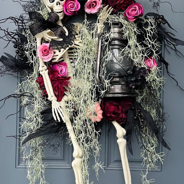 Halloween skeleton door wreath with a lantern that lights up, Moveable 36" skeleton holds light and is nestled in creepy moss and pink roses