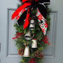 Christmas front door swag with Silver metal bells. Mixed pine with natural pinecones and red berries with twigs topped with a stunning bow!