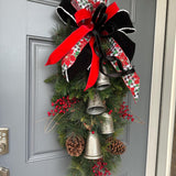 Christmas front door swag with Silver metal bells. Mixed pine with natural pinecones and red berries with twigs topped with a stunning bow!