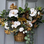 Basket wreath for front door,arrangement with magnolia florals and greenery with a touch of natural pods. Stunning southern design 24"x21"x6