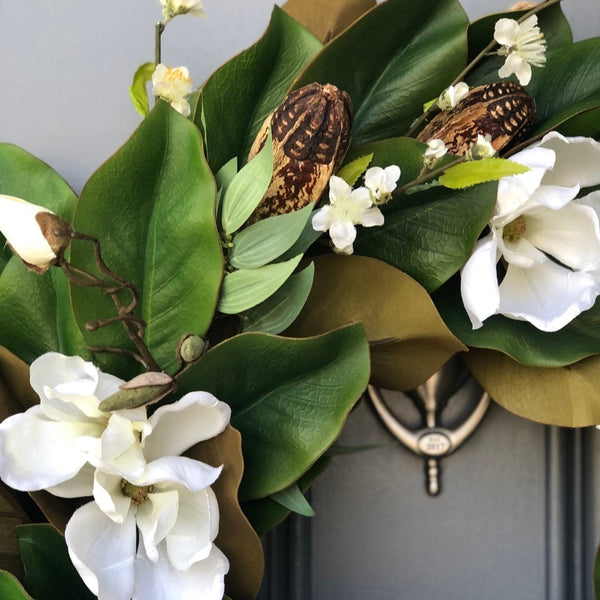Magnolia wreath for front door with realistic white magnolia blooms nestled in green magnolia leaves with pods