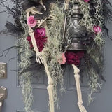 Halloween skeleton door wreath with a lantern that lights up