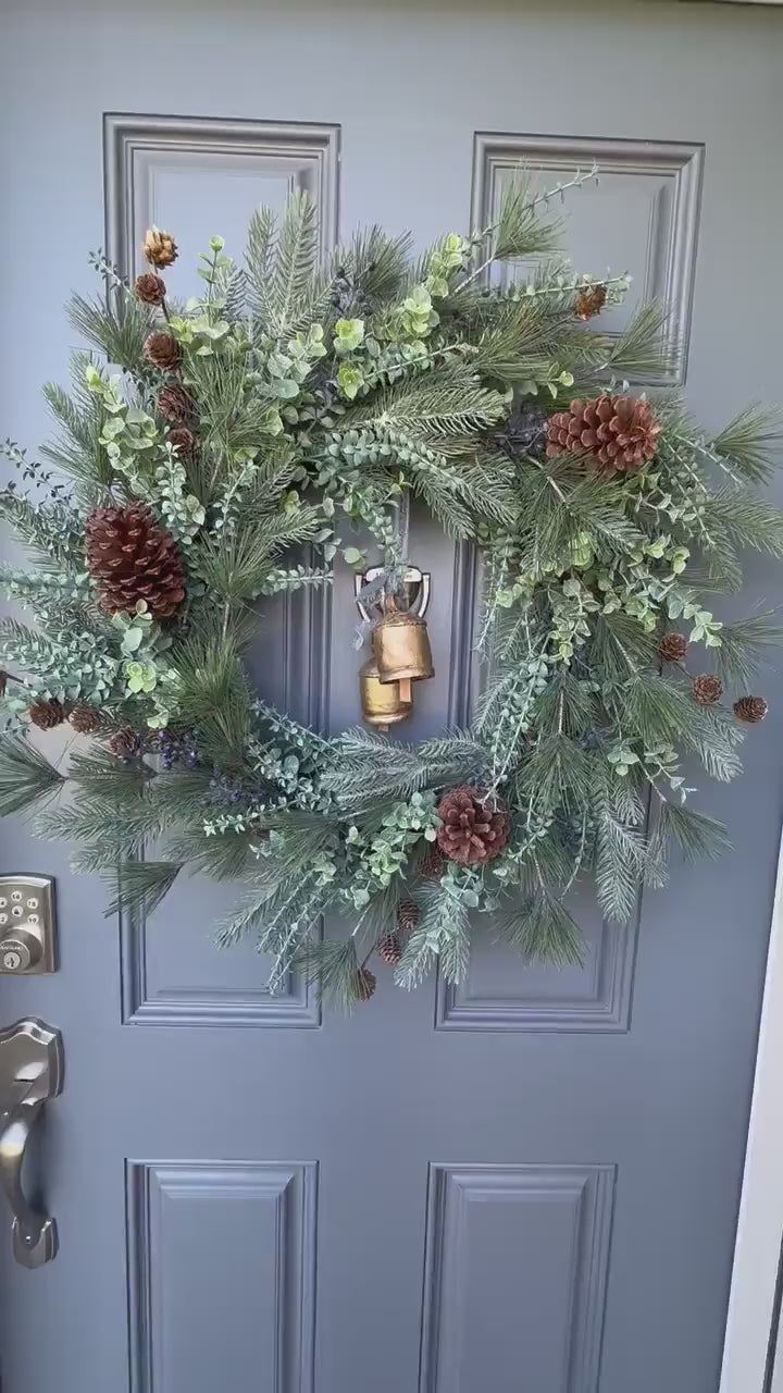 Winter front door wreath with brass bells