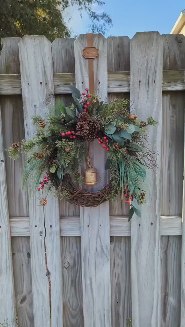 Rustic holiday winter wreath with brass bell. Faux natural wreath for entire season. This quaint wreath is perfect to welcome your guests!