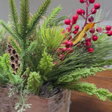 Christmas table arrangement in a birch container. Christmas gift arrangement