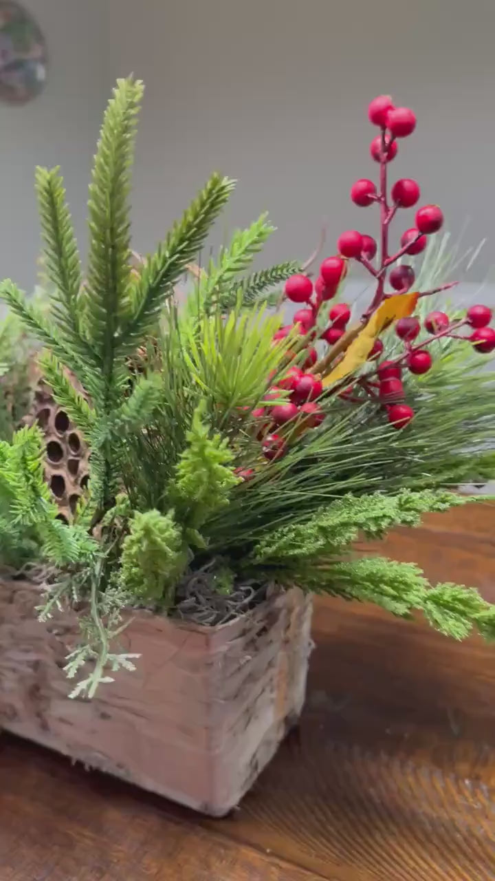 Christmas table arrangement in a birch container. Christmas gift arrangement