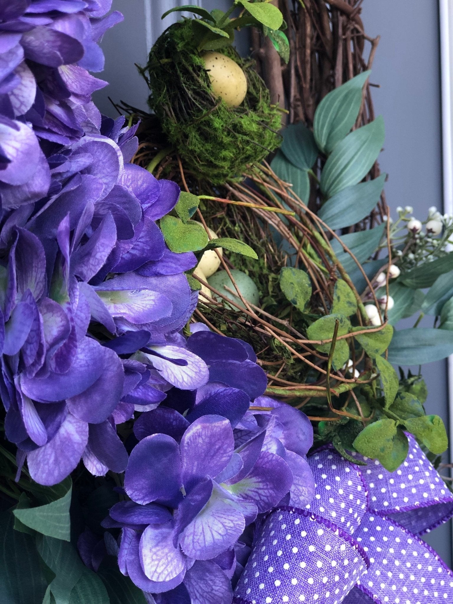 Purple spring front door wreath, purple hydrangeas, a bird nest with eggs