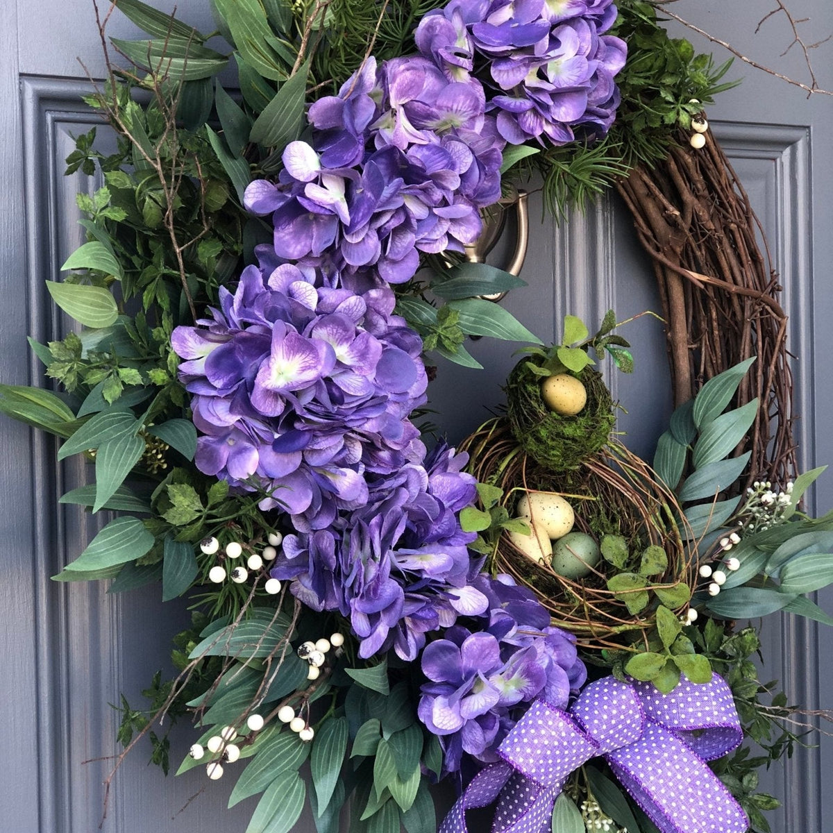 Purple spring front door wreath, purple hydrangeas, a bird nest with eggs
