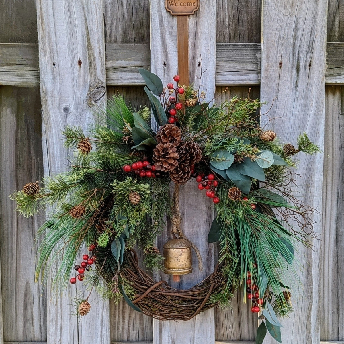 Rustic holiday winter wreath with brass bell. Faux natural wreath for entire season. This quaint wreath is perfect to welcome your guests!