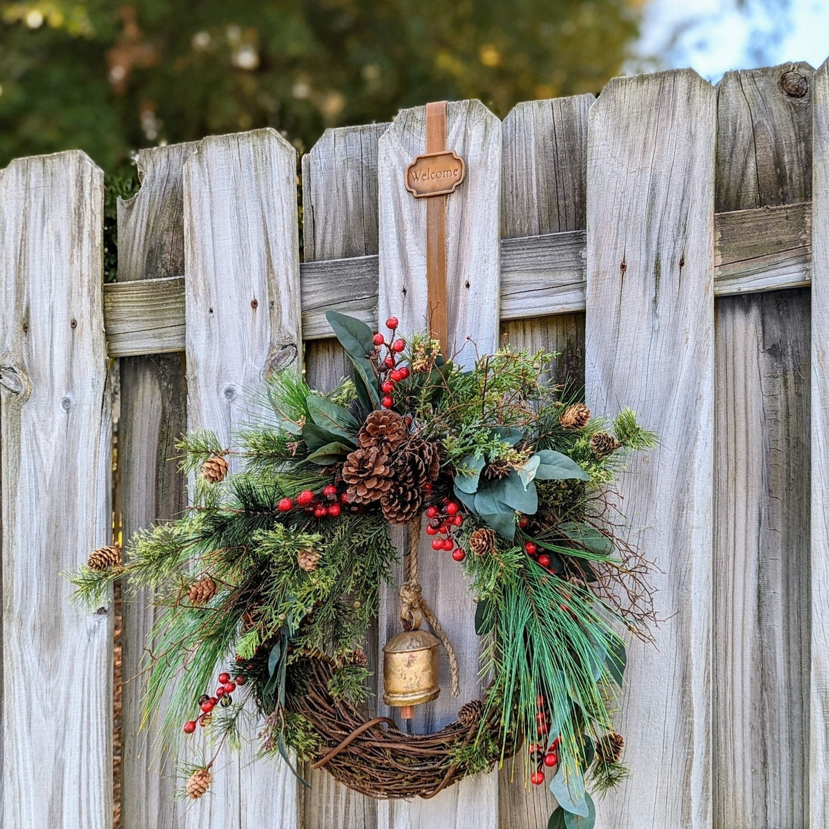 Rustic holiday winter wreath with brass bell. Faux natural wreath for entire season. This quaint wreath is perfect to welcome your guests!