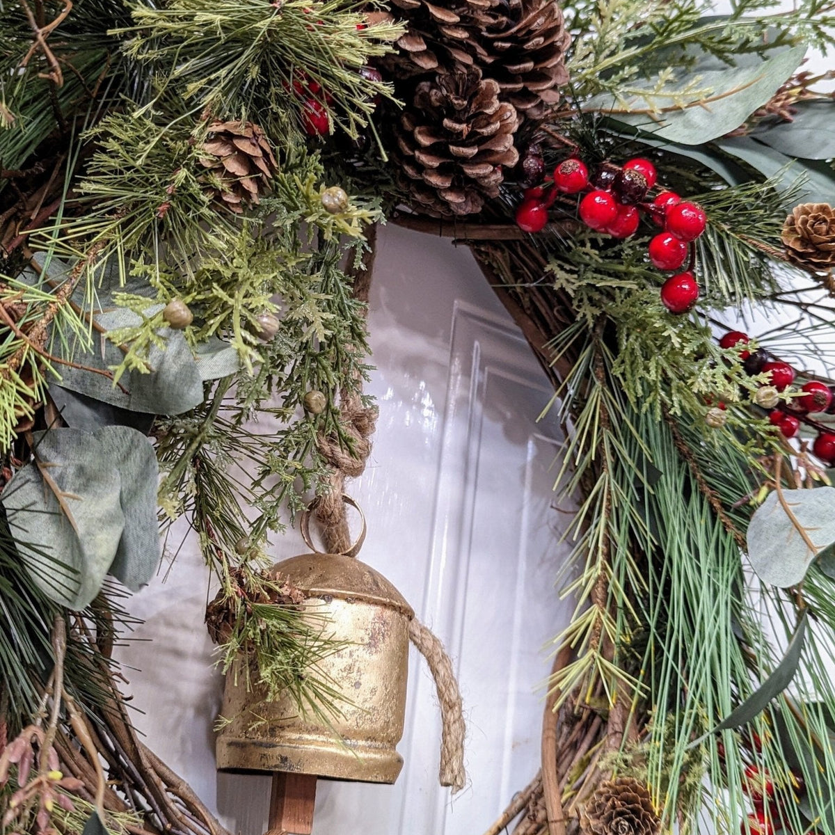 Rustic holiday winter wreath with brass bell. Faux natural wreath for entire season. This quaint wreath is perfect to welcome your guests!