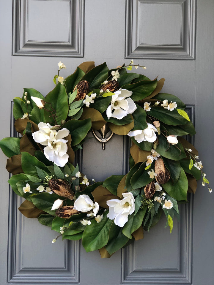 Magnolia wreath for front door with realistic white magnolia blooms nestled in green magnolia leaves with pods