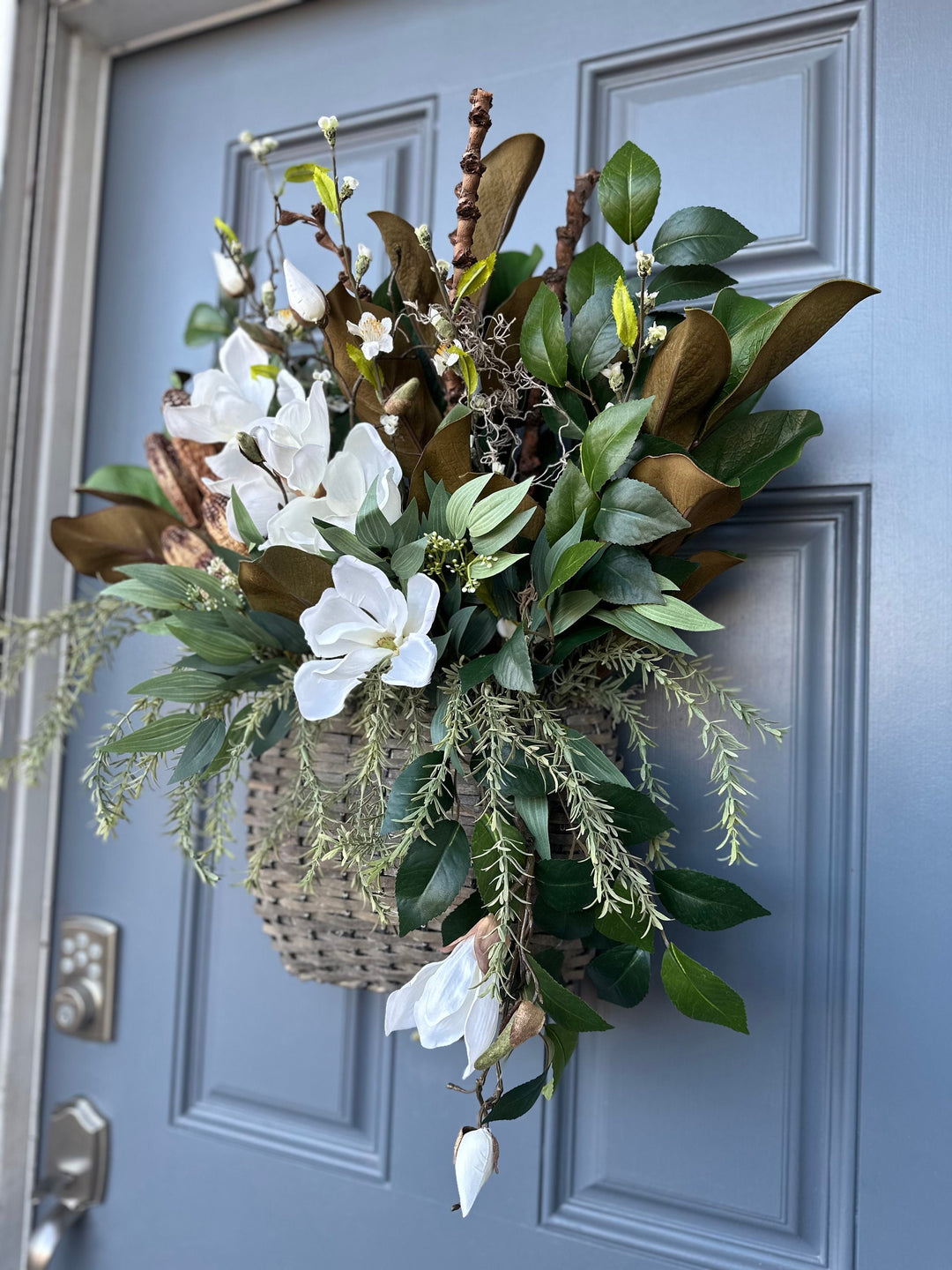 Basket for front door arrangement with magnolia florals and greenery with a touch of natural branches and pods 24"x21"x5. Matches wreath!!!